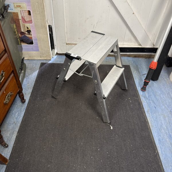 Silver aluminium folding step stool for household use.