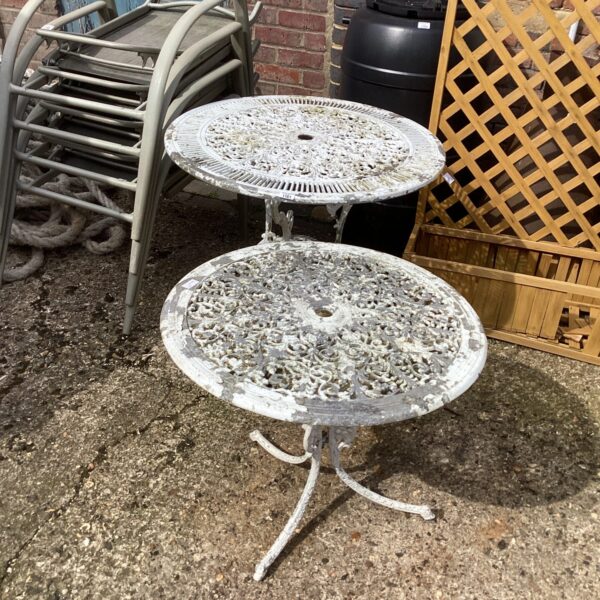 Vintage metal garden table with detailed floral design.
