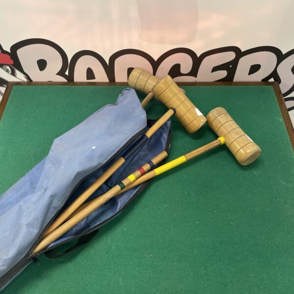 Vintage children’s croquet set with wooden mallets and balls.