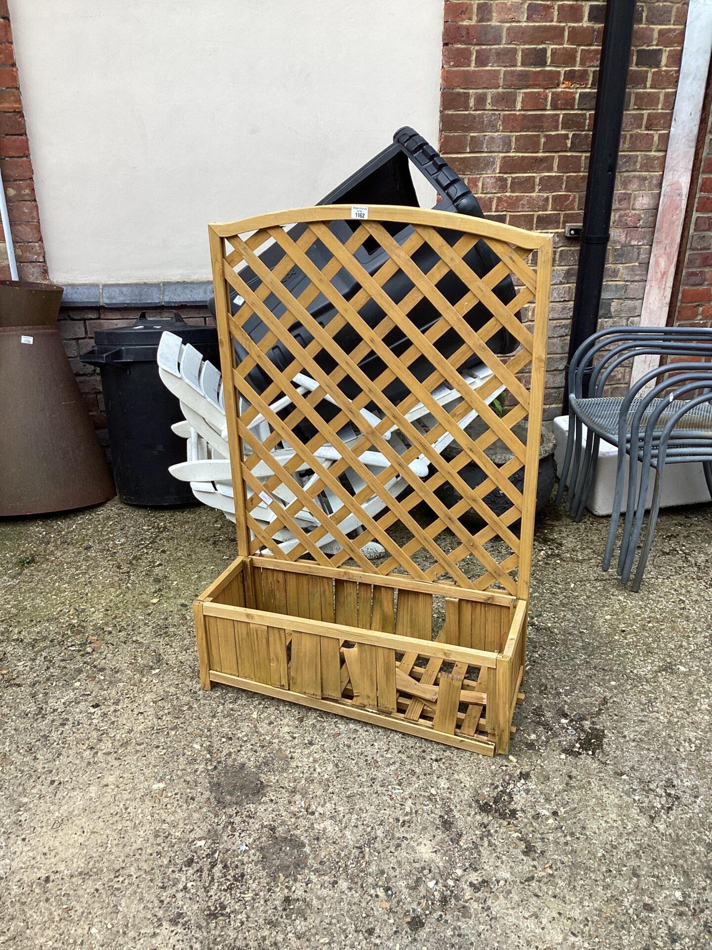 1162 Wooden garden planter with trellis in need ofrepair