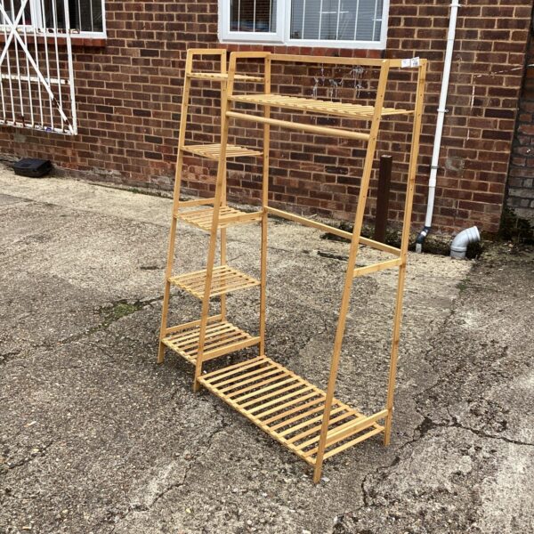 Wooden slatted shoe rack and clothes rail for hallway storage.