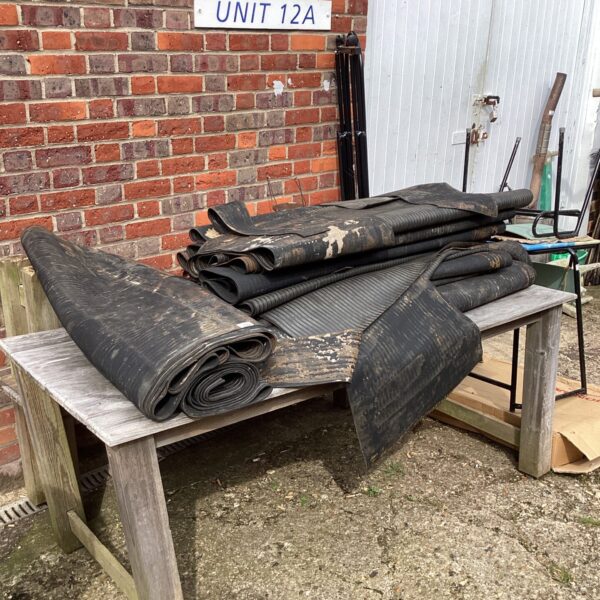 Large roll of heavy-duty rubber matting for workshop flooring.