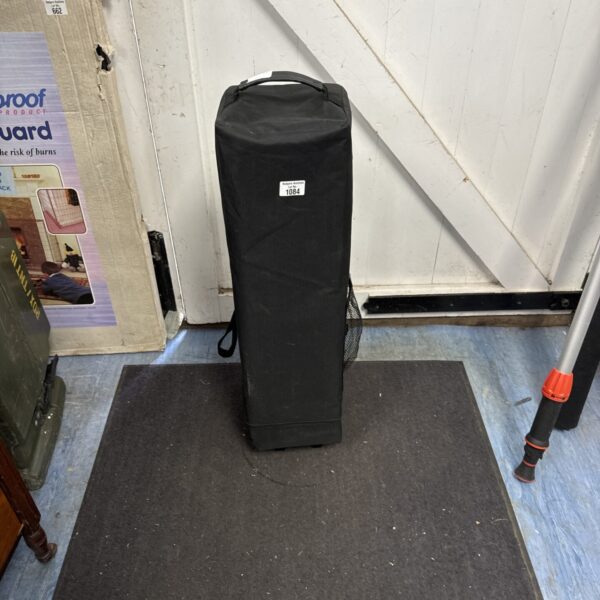 Folded portable travel cot, ready for storage or transport.