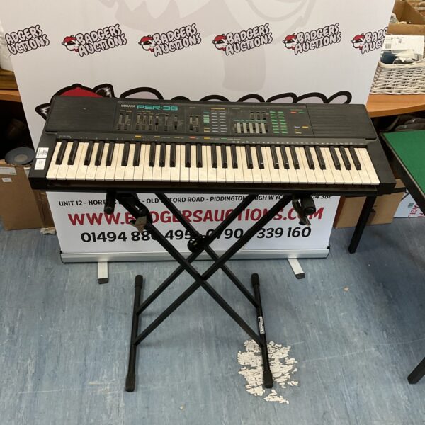 Yamaha PSR-36 electronic keyboard with stand, vintage musical instrument.