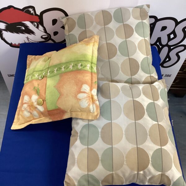 Three floral patterned cushions for home decor.