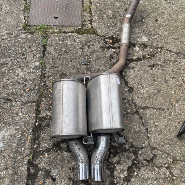 Large stainless steel exhaust pipe with dual outlet design.