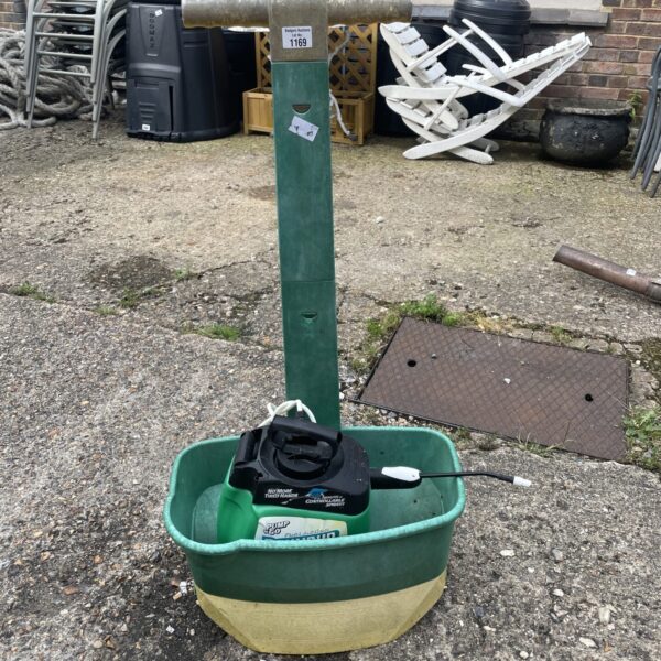 Handheld lawn feeder for applying granular fertiliser to a garden.