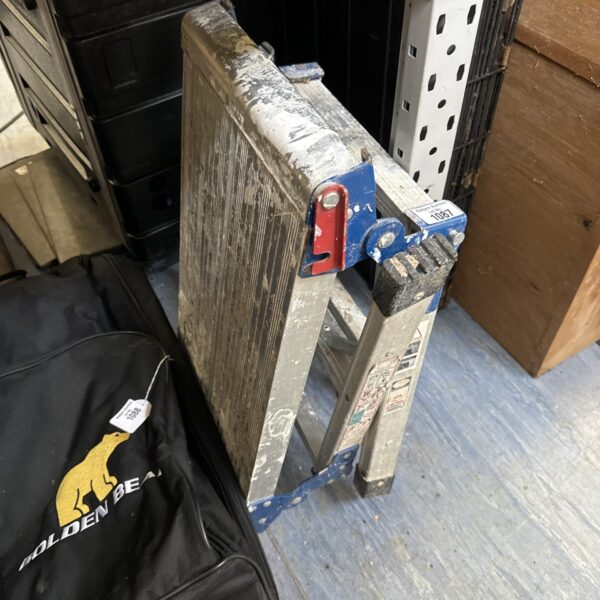Aluminium decorators step ladder, folded for storage.