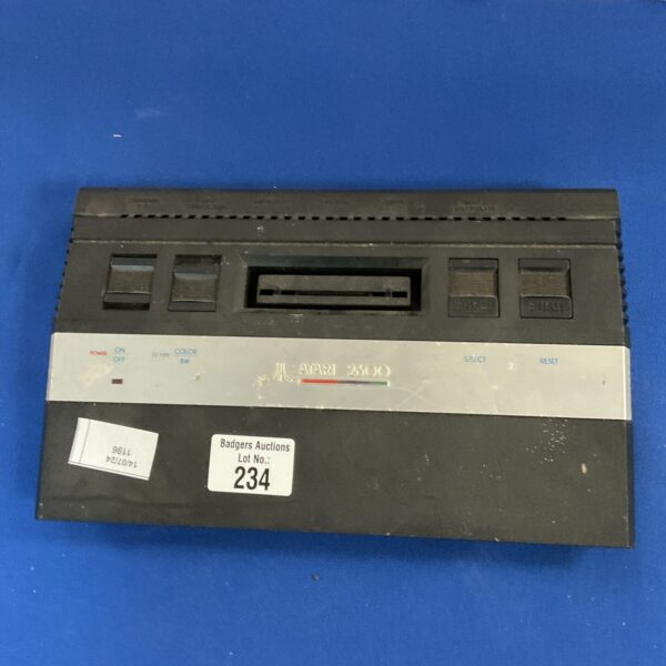 Vintage Atari 2600 console with woodgrain finish.