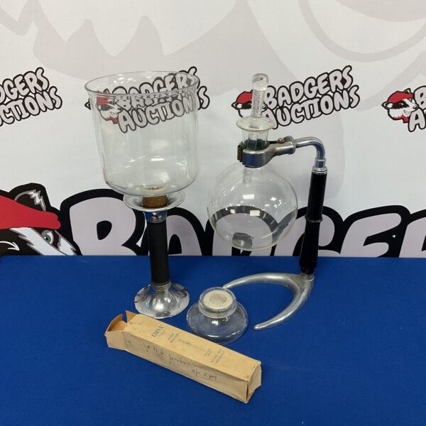 Vintage Cona coffee maker with glass carafe and metal components.