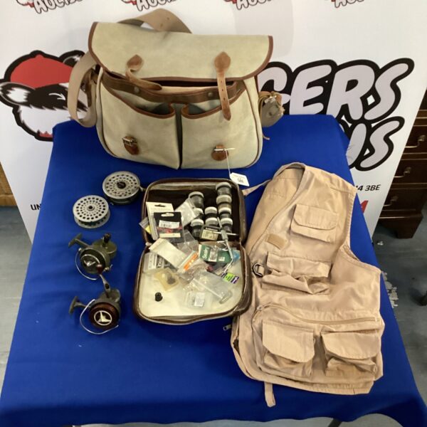 Fly fishing tackle lot with vest, reels and hooks.