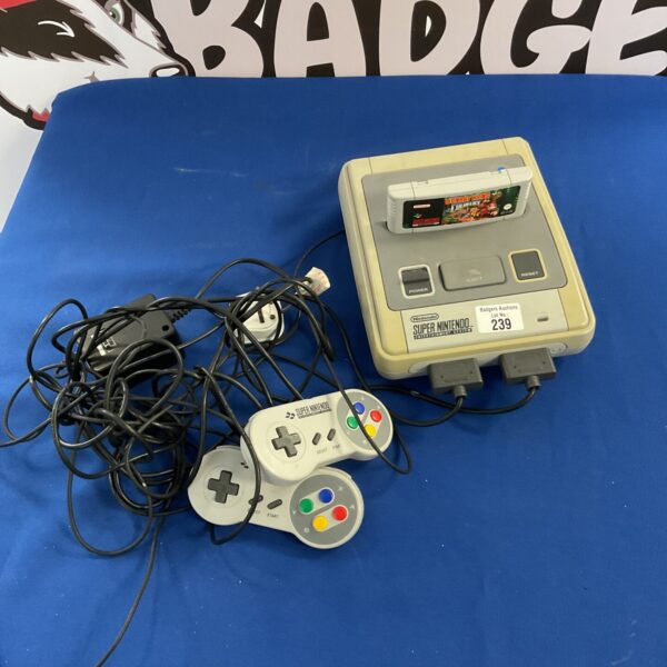 Super Nintendo Entertainment System with Donkey Kong Country cartridge.