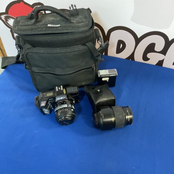 Vintage Minolta 35mm camera with case and accessories for film photography.