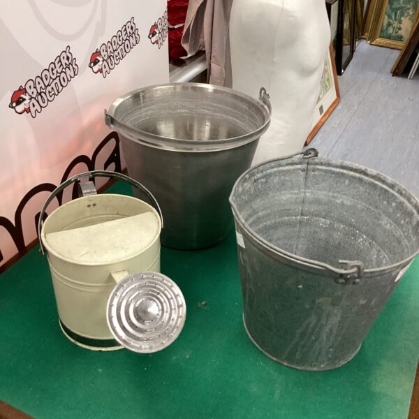 Two metal buckets, one galvanised and one stainless steel, for storage.