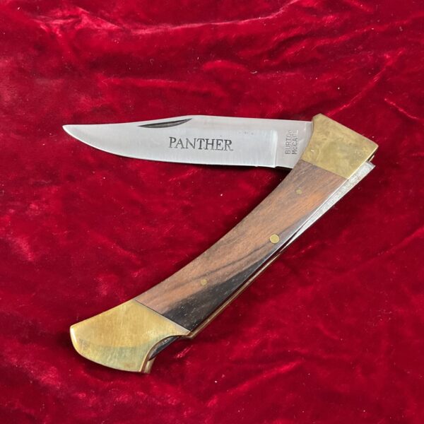 Vintage Panther pocket knife with wood and brass handle.