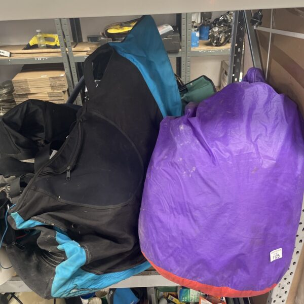 Complete paragliding set with wing and chair for outdoor adventure.