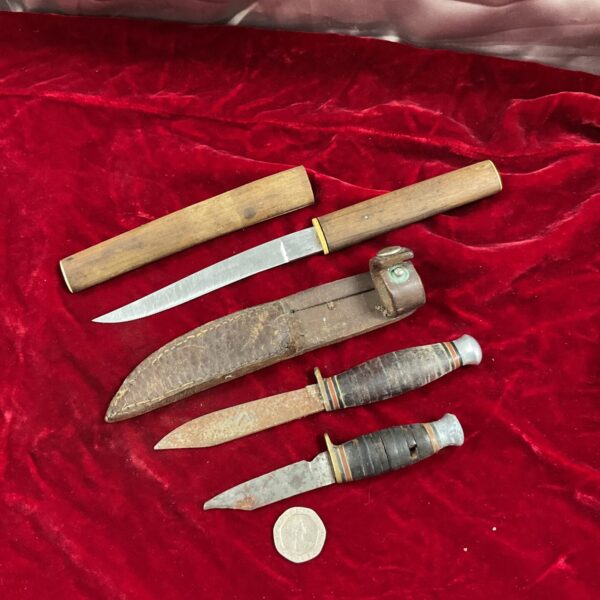 Lot of three vintage fixed blade knives with wooden handles.