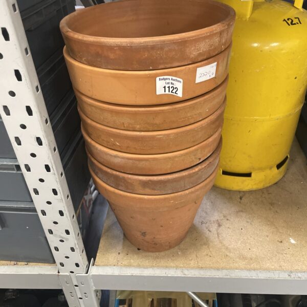 Lot of seven terracotta plant pots for garden use.