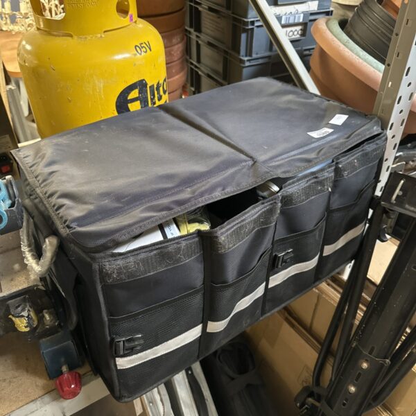 Blue canvas motoring tool bag with various tools inside.
