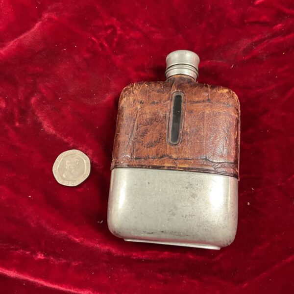 Vintage pewter hip flask with leather casing.