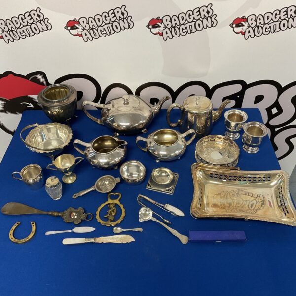 Antique silver plate tea and coffee set with ornate detailing.
