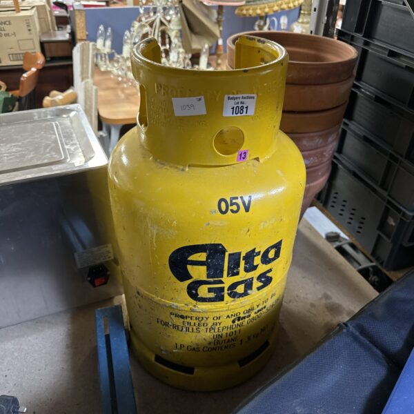 Yellow Alta patio gas bottle with some remaining contents.