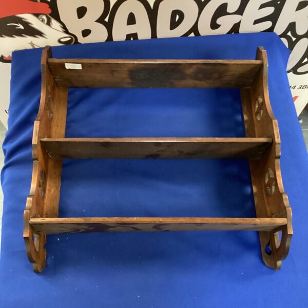 Vintage wooden wall shelf with rustic detailing.