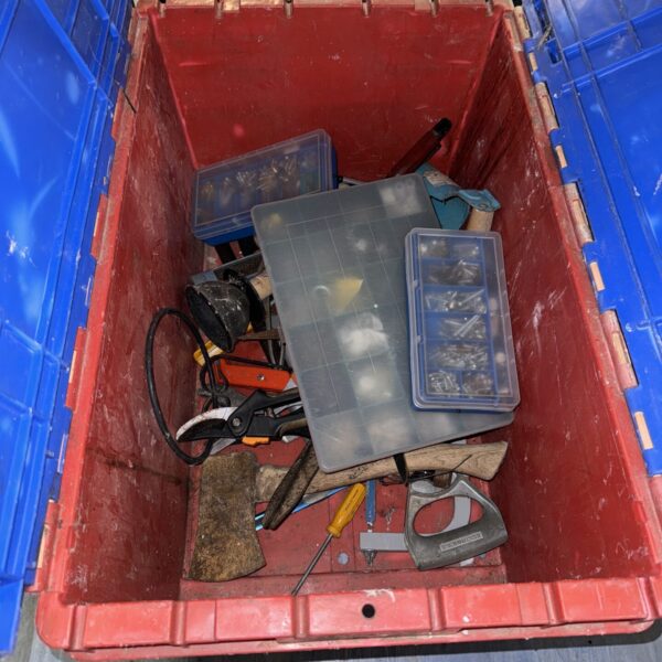 Blue crate filled with assorted hand tools for workshop or garage.