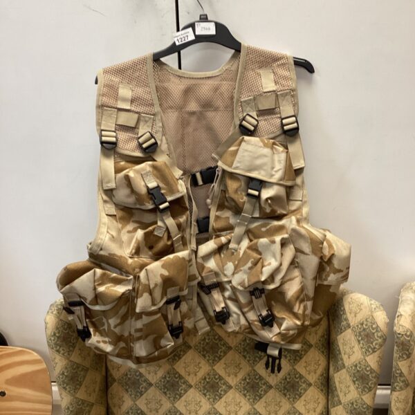 Front view of a desert camo assault vest with MOLLE webbing.