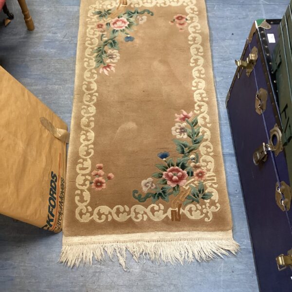 Vintage floral runner rug with embroidered flowers and a neutral background.