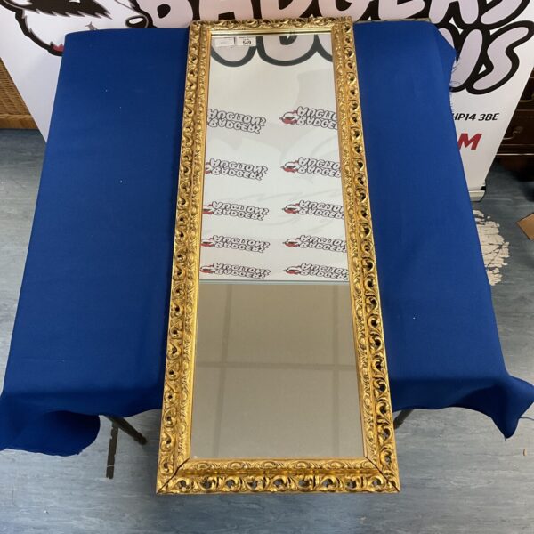 Ornate gilt framed mirror, antique style wall decor.