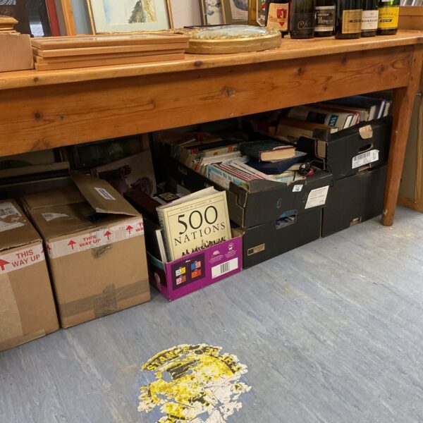 Stack of boxes and crates filled with a book lot collection.