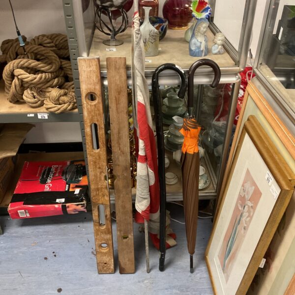 Vintage walking sticks, spirit levels, and a Union Jack flag lot.