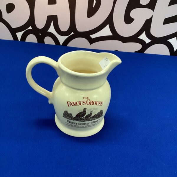 Vintage Famous Grouse water jug with iconic branding.