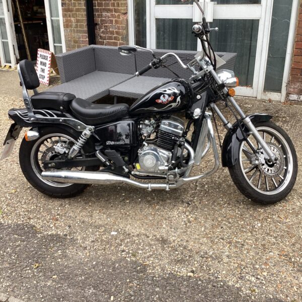 Black and chrome AJS DD125E motorcycle, side view.