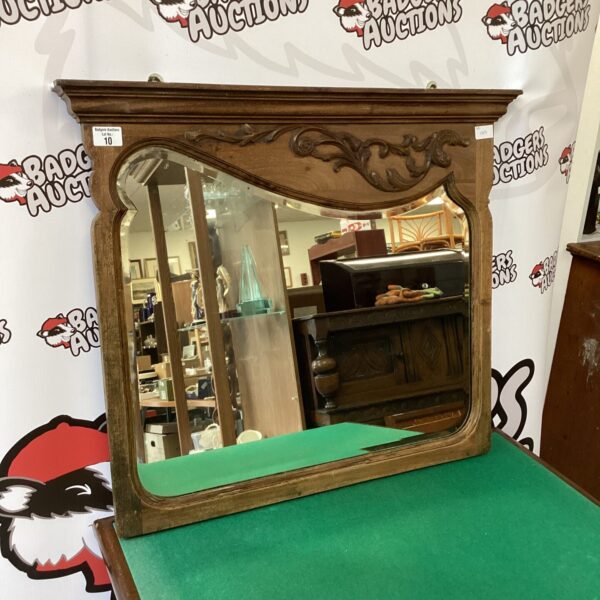 Vintage Arts and Crafts oak overmantle mirror with carved details.