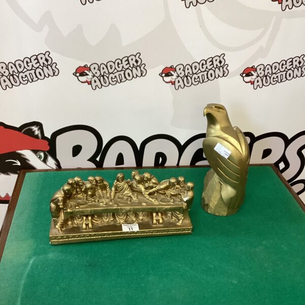 Golden resin Last Supper and eagle figurine set for display.