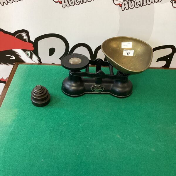 Vintage Salter kitchen scales with weights on a dark surface.