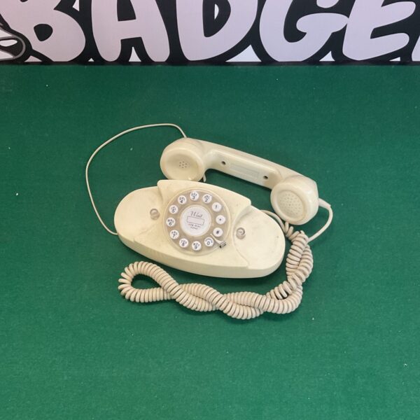 Beige vintage push button telephone, retro style.