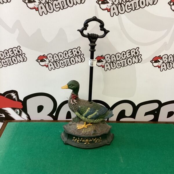 Antique cast iron duck door stop for farmhouse decor.