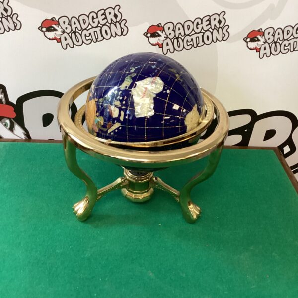 Detailed blue lapis globe on a gold stand.