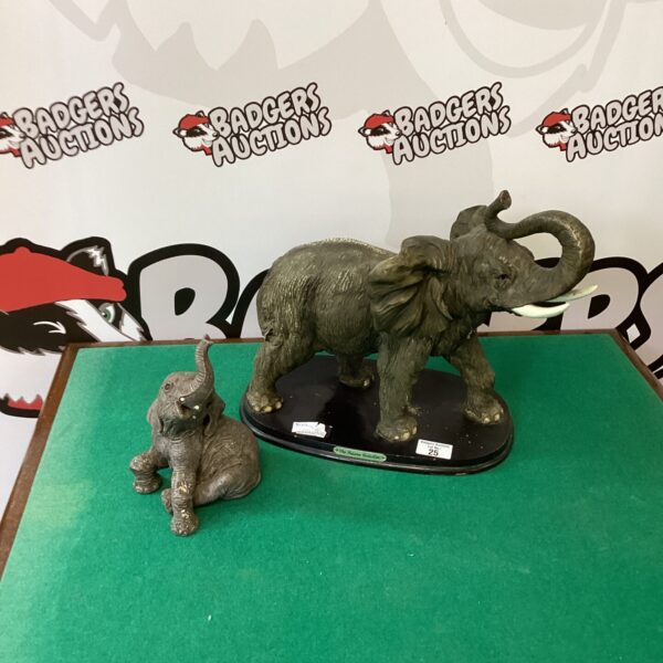 Pair of detailed resin elephant figurines for home decor.