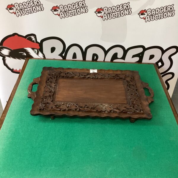 Intricate antique carved oak serving tray with raised edges.