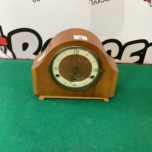 Vintage Andrews wooden chiming clock with a circular dial.