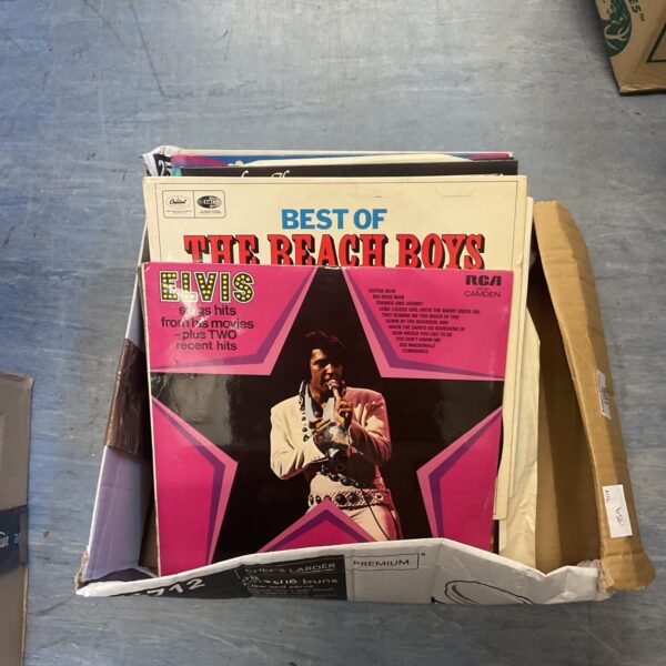 Vintage vinyl LP records by Elvis Presley and The Beach Boys.