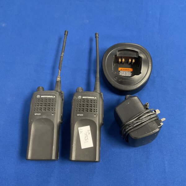 Pair of used Motorola GP320 walkie talkies in close-up view.