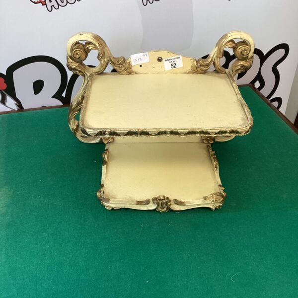 Ornate antique French style telephone shelf for vintage decor.