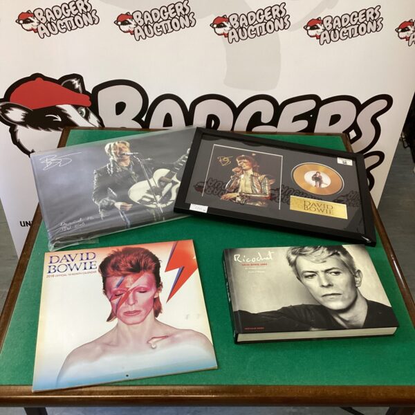 David Bowie memorabilia collection featuring signed items and promotional materials.