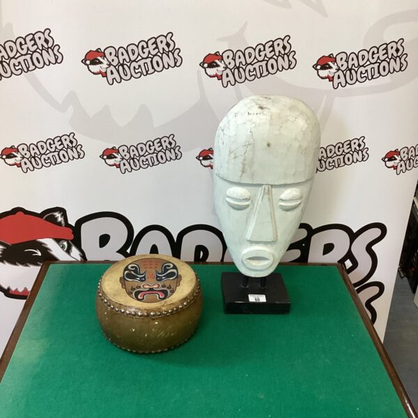 Authentic African drum and carved wooden mask set for collectors.