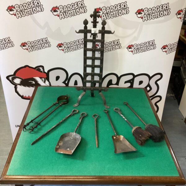 Antique Gothic fire companion set with ornate detailing on a table.